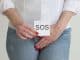 woman-covers-groin-by-hand
