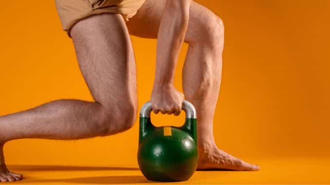 Muscular men legs in a squat