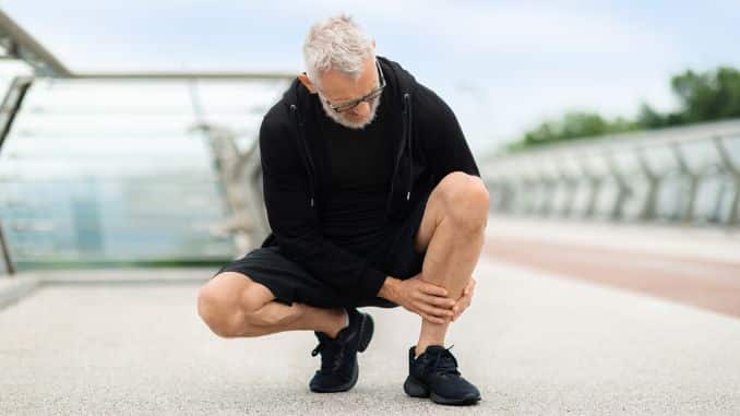 -Senior man jogging by bridge