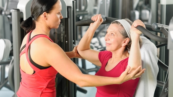 senior woman with personal trainer