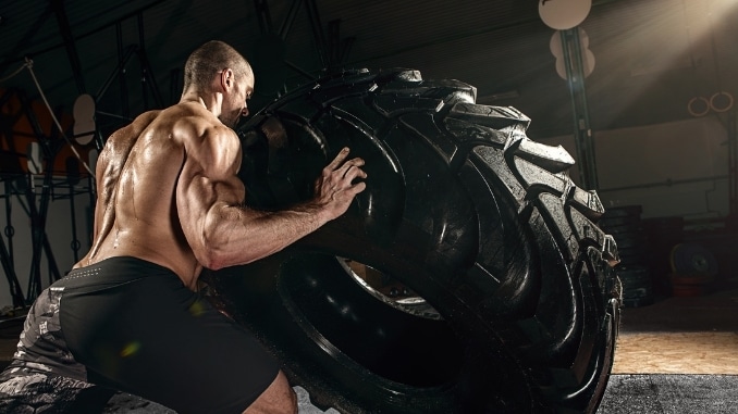 strong man flipping tire