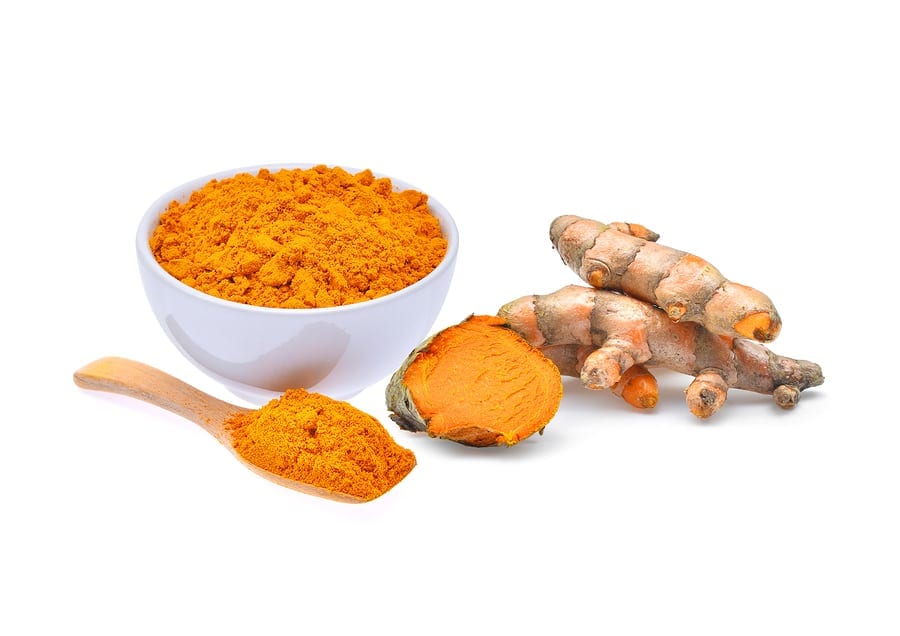 dried turmeric powder and turmeric root isolated on white background