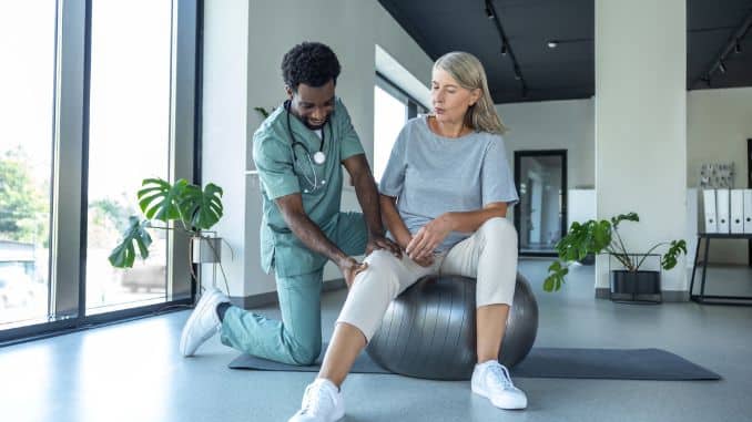 physiotherapist-guiding-woman-knee physiotherapist-guiding-woman-knee
