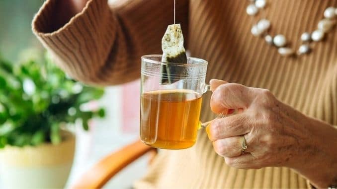 holding-glass-of-tea - How to Keep Your Brain Sharp as You Age