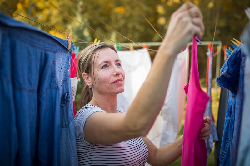 woman-putting-laundry-on-a-rope