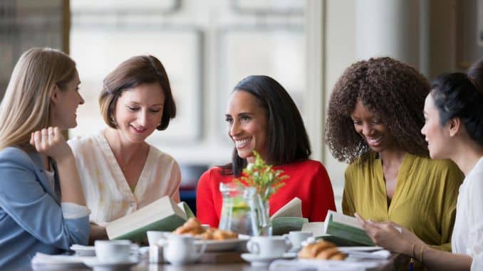 women-friends-discussing-book - how to be active in your community