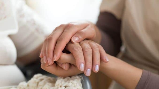 Caregiver-holding-senior-womans