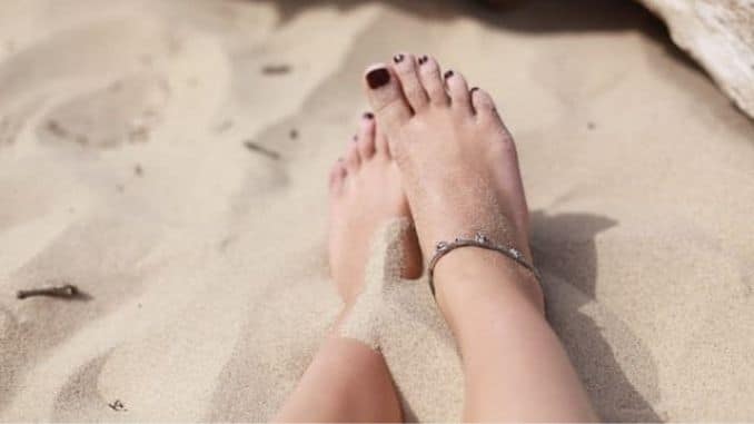 human-feet-on-white-sand