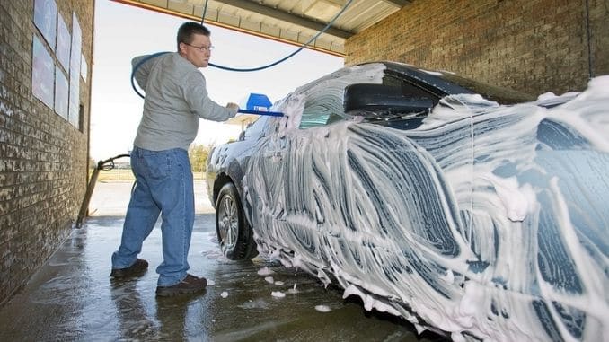 Man-washing-his-sports-car - Side Hustles to Bring in Extra Money