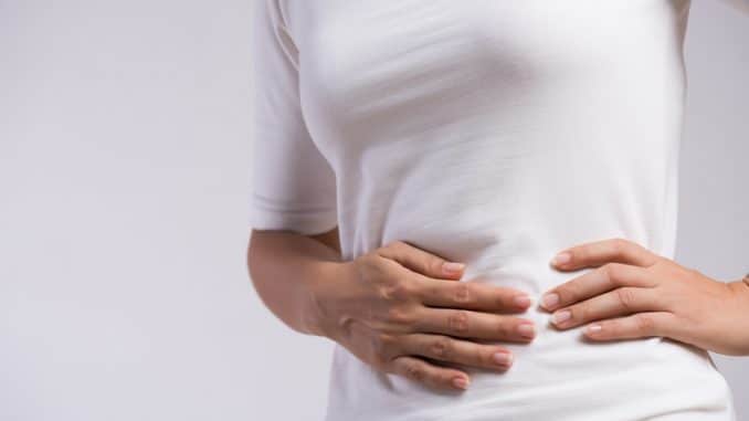 Young woman having painful stomachache. Chronic gastritis. Abdom