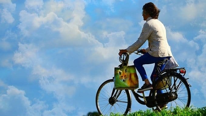 woman-cyclist-bicycle - Exercises to Help You Reduce Your Risk of Dementia
