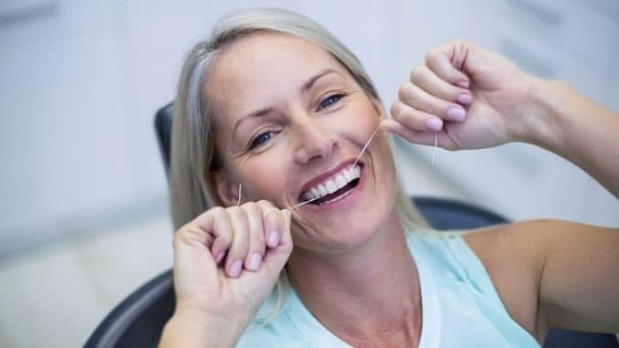 Woman-flossing-teeth