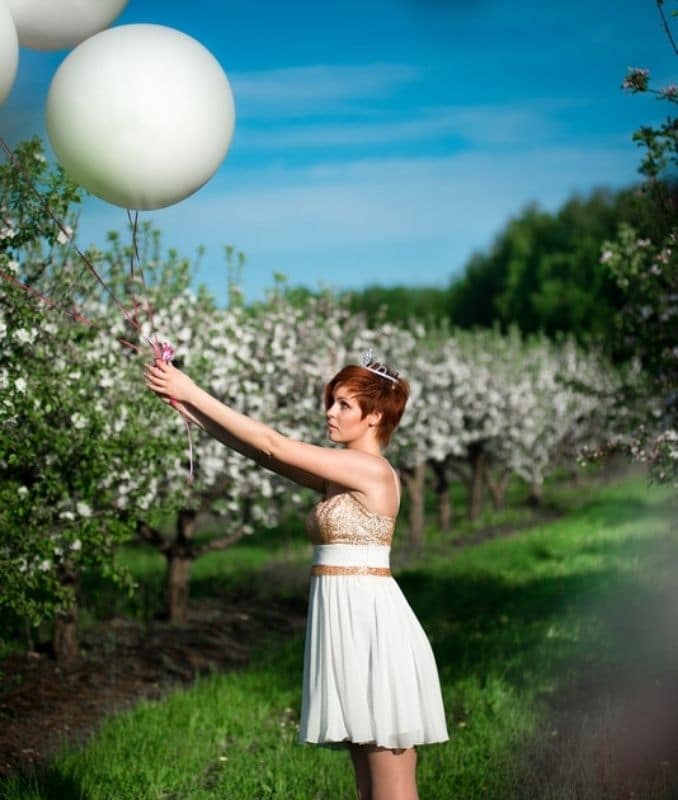 girl-holding-white-balloons