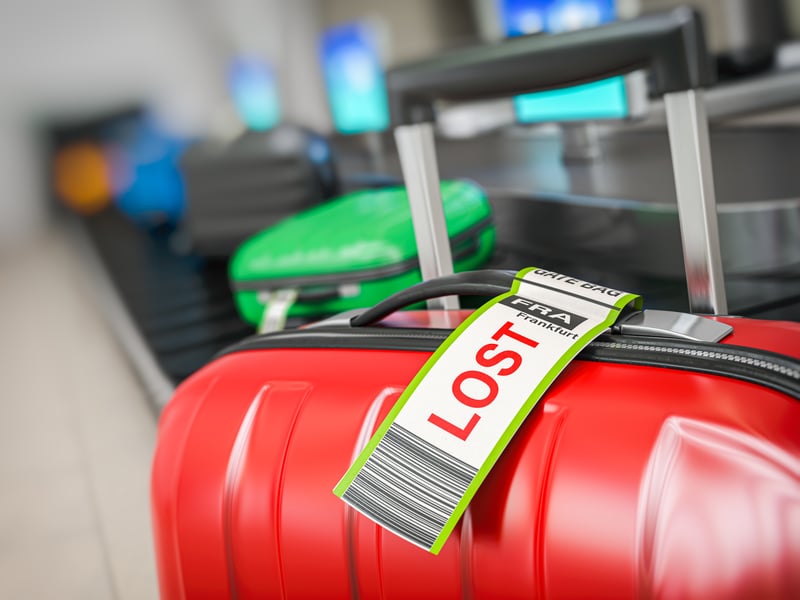 Suitcase with lost sticker on an airport baggage conveyor or bag