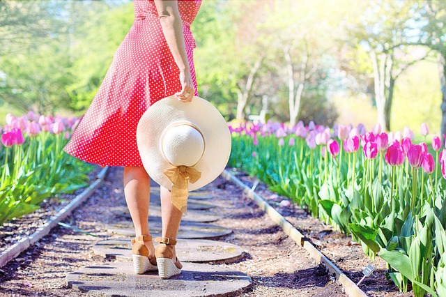 garden-woman-walking-hat-tulips