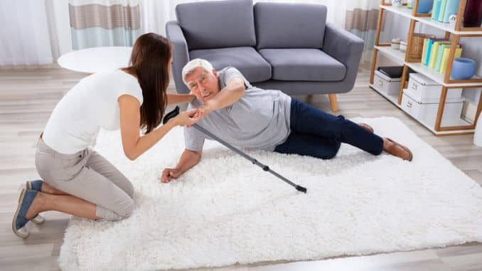 woman helping her father to get up-Exercises To Prevent Falls In Seniors
