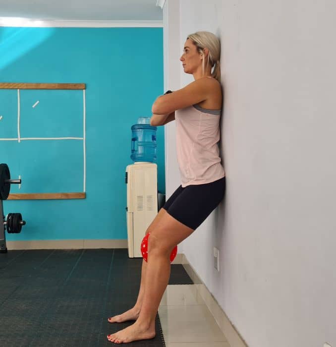 Wall squats with ball squeeze 1