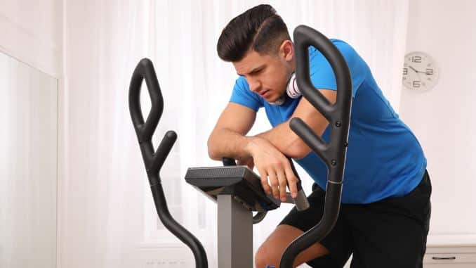 tired-man-training-modern-elliptical